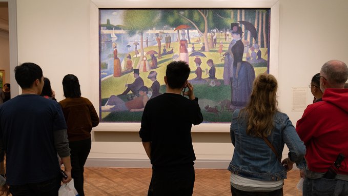 people looking at a piece of art