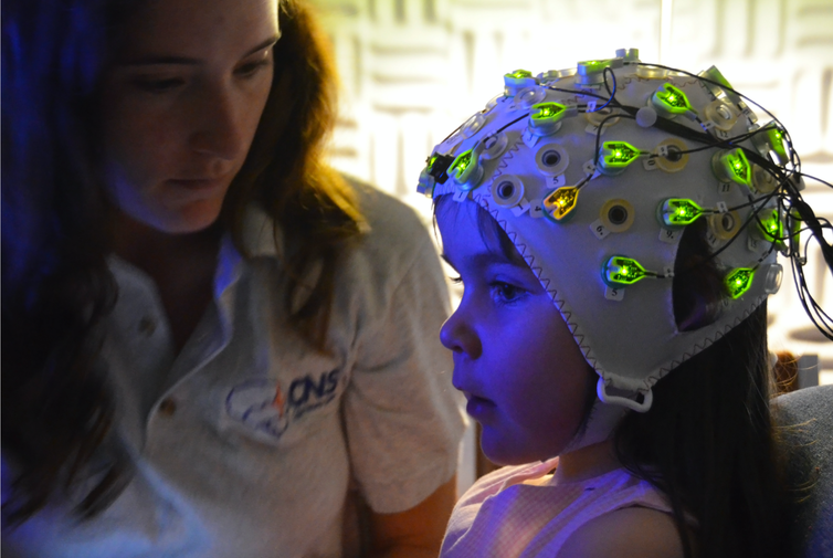 Researchers fitted children with EEG caps to monitor their brains’ electrical activity as they watched an adult distribute treats