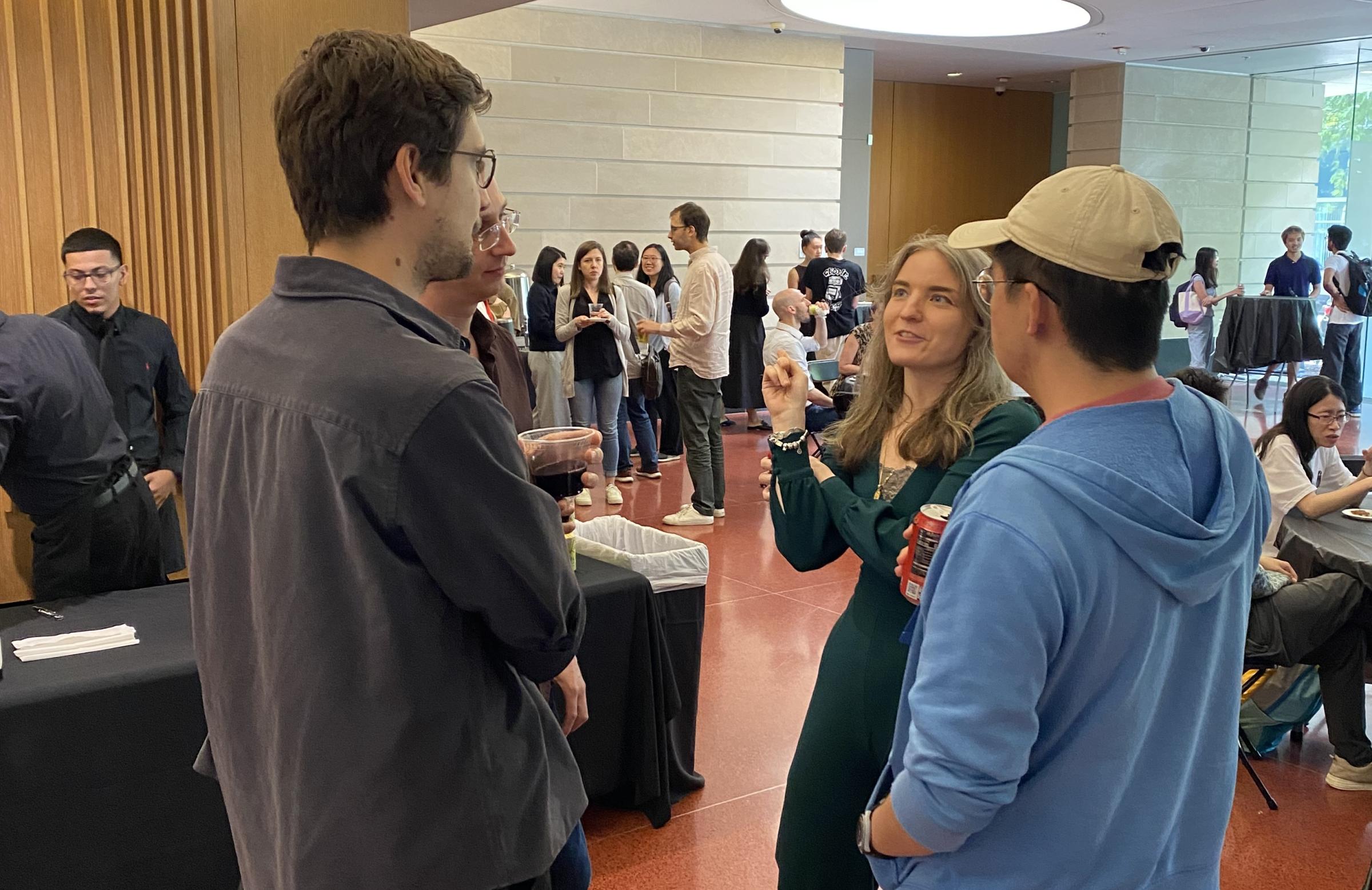 Trainees chatting at the symposium