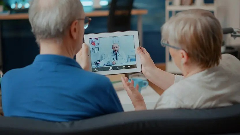 two people looking at an iPad