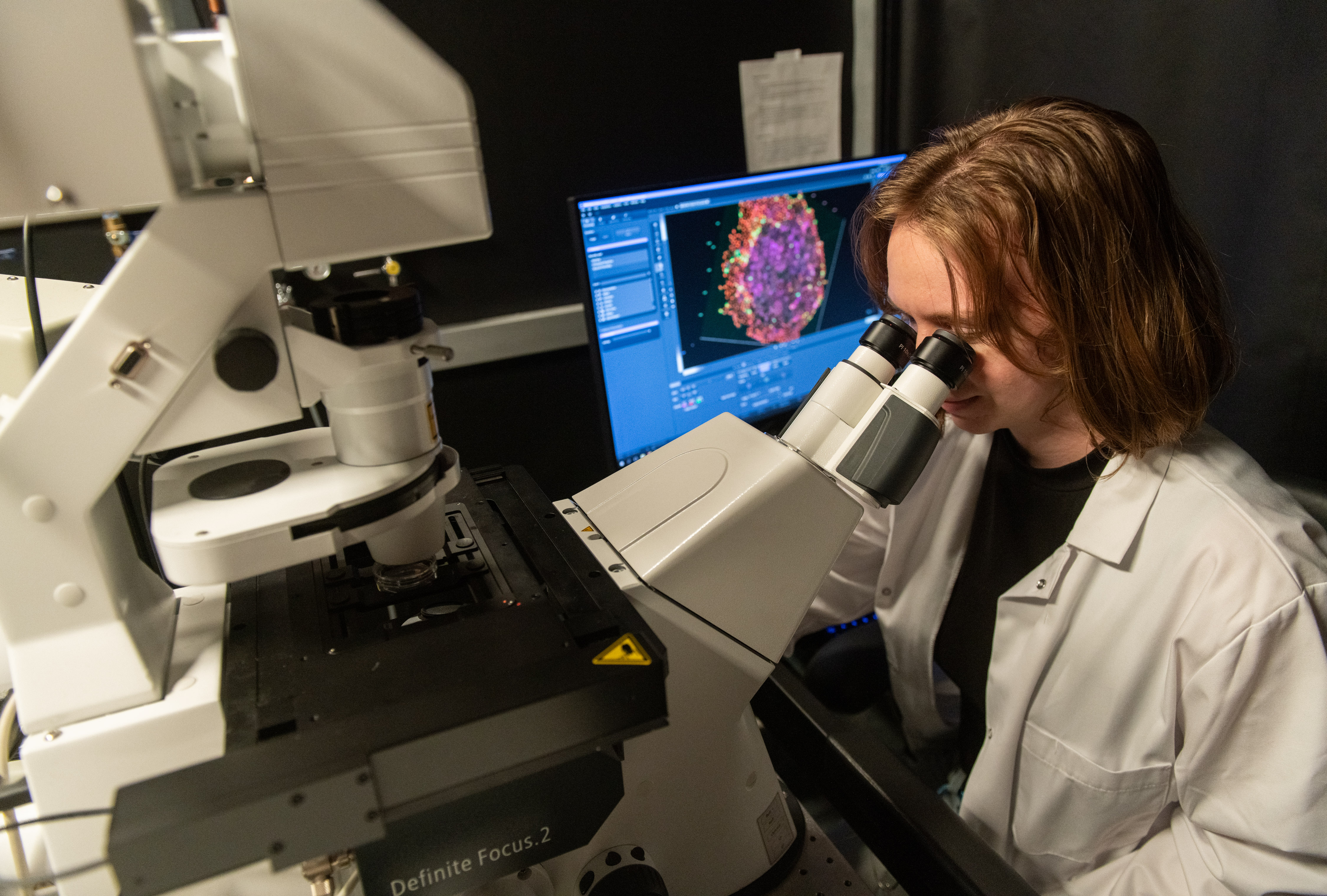 student looking at microscope