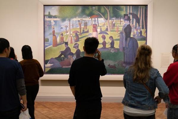 people looking at a piece of art