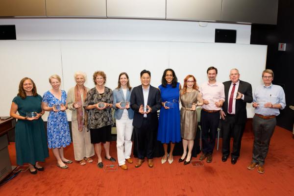Faculty members hold their award