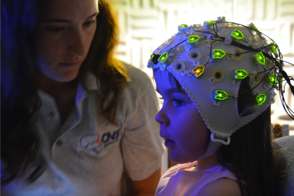 Researchers fitted children with EEG caps to monitor their brains’ electrical activity as they watched an adult distribute treats