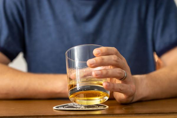 hand holding a glass of whiskey