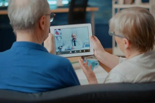 two people looking at an iPad